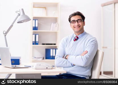 Young handsome businessman employee working in office at desk