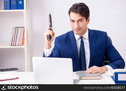 Young handsome businessman employee working in office at desk