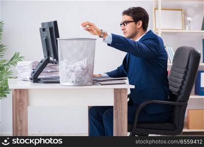 Young handsome businessman employee working in office in paperwo. Young handsome businessman employee working in office in paperwork concept