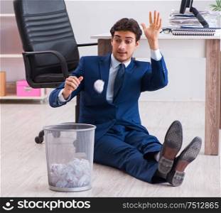Young handsome businessman employee working in office in paperwork concept. Young handsome businessman employee working in office in paperwo