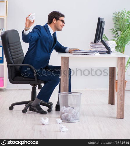 Young handsome businessman employee working in office in paperwork concept. Young handsome businessman employee working in office in paperwo