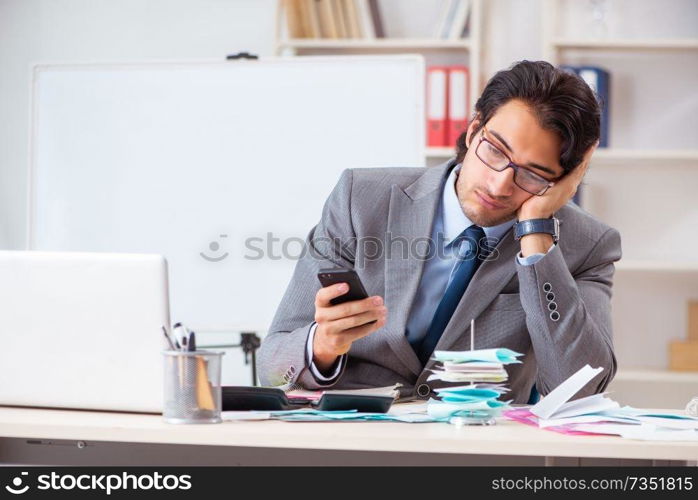 Young handsome businessman in budget planning concept 