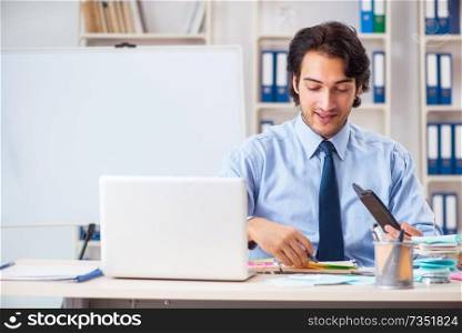 Young handsome businessman in budget planning concept 
