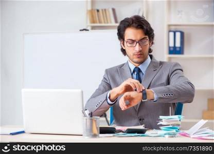 Young handsome businessman in budget planning concept 