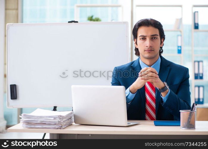 Young handsome businessman in front of whiteboard 