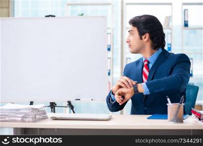 Young handsome businessman in front of whiteboard