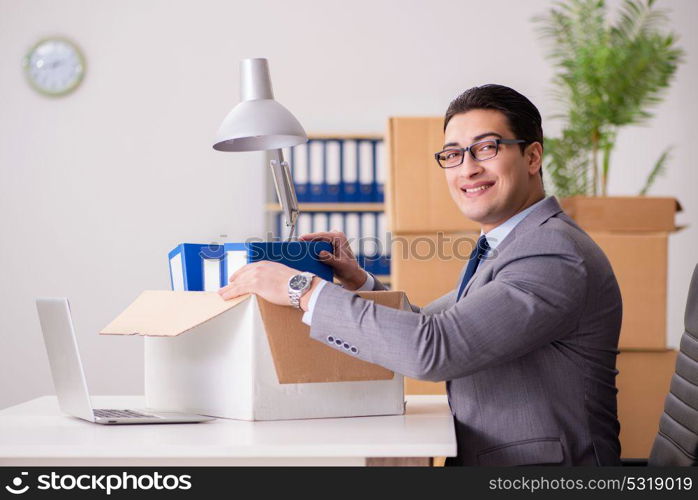 Young handsome businessman moving offices