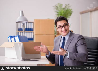 Young handsome businessman moving offices