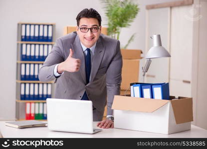 Young handsome businessman moving offices