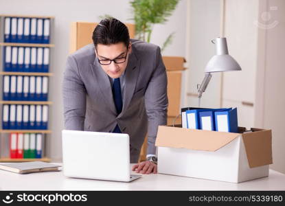 Young handsome businessman moving offices