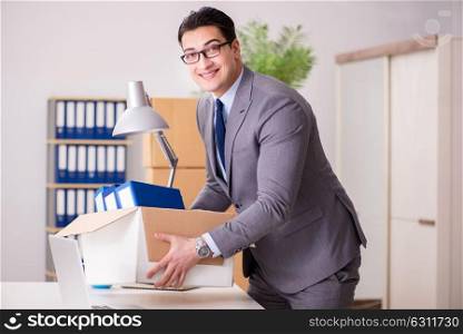 Young handsome businessman moving offices
