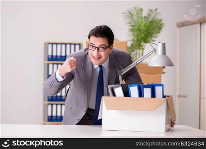 Young handsome businessman moving offices