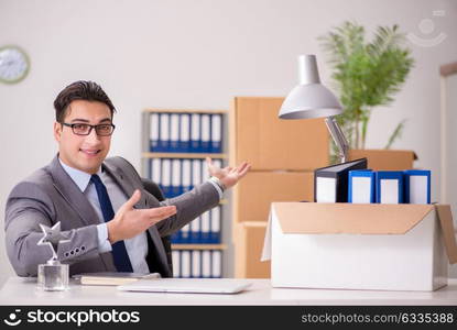 Young handsome businessman moving offices