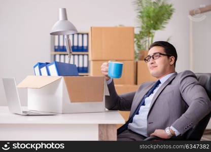 Young handsome businessman moving offices