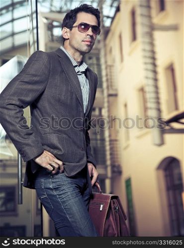 Young handsome businessman posing
