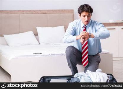 Young handsome businessman preparing for trip