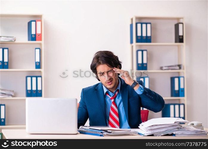 Young handsome businessman sitting in the office  . Young handsome businessman sitting in the office 