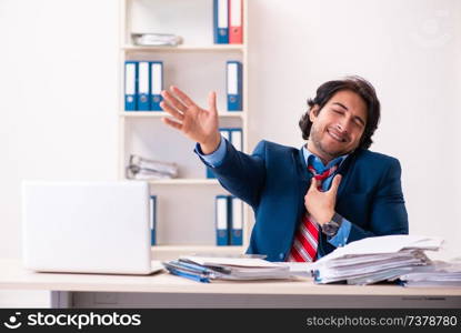 Young handsome businessman sitting in the office  . Young handsome businessman sitting in the office 