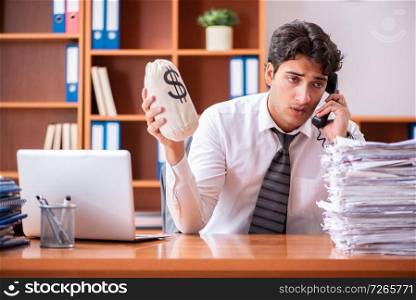 Young handsome businessman unhappy with excessive work 