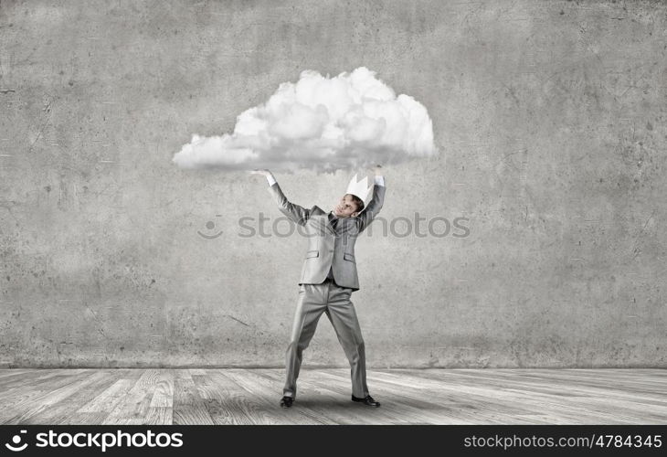 Young handsome businessman wearing white paper crown