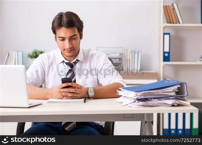 Young handsome businessman working in office