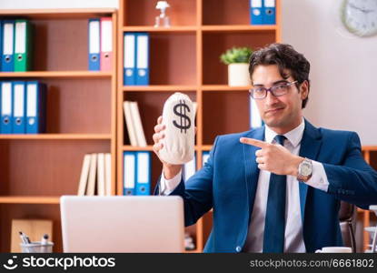 Young handsome businessman working in the office