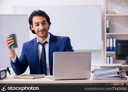 Young handsome businessman working in the office