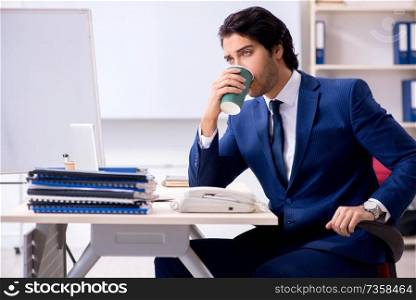 Young handsome businessman working in the office