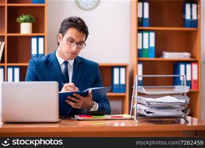 Young handsome businessman working in the office. The young handsome businessman working in the office