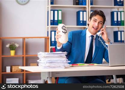 Young handsome businessman working in the office . The young handsome businessman working in the office 