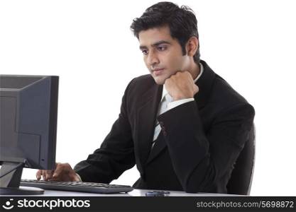 Young handsome businessman working on computer