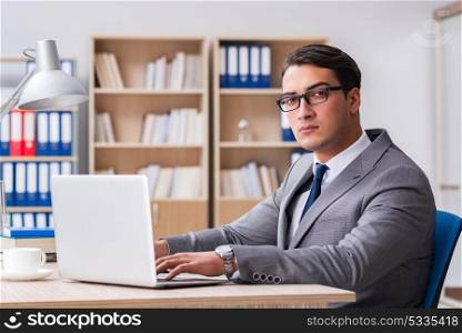 Young handsome businessman working on office