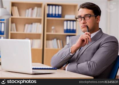 Young handsome businessman working on office