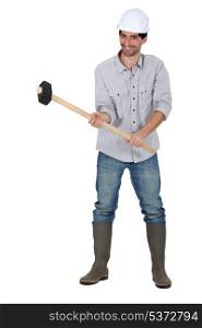 young handsome carpenter holding hammer isolated on white
