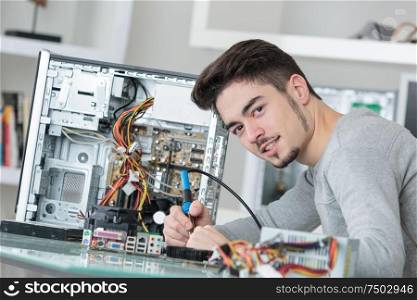 young handsome computer repairer concentrated on his work