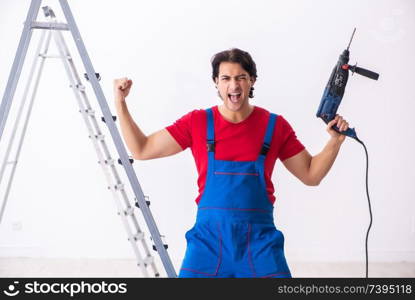 Young handsome contractor working indoors 