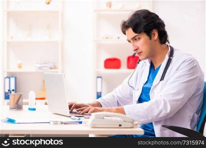 Young handsome doctor in telehealth concept 