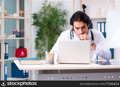 Young handsome doctor in telemedicine concept 