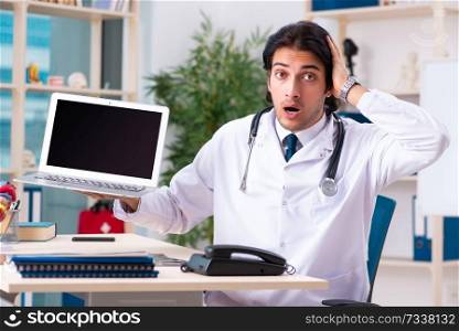 Young handsome doctor in telemedicine concept 