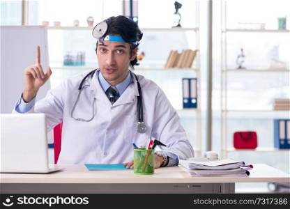 Young handsome doctor otolaryngologist in front of whiteboard 