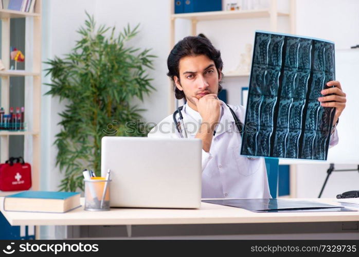 Young handsome doctor radiologist working in the clinic 