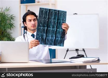 Young handsome doctor radiologist working in the clinic 