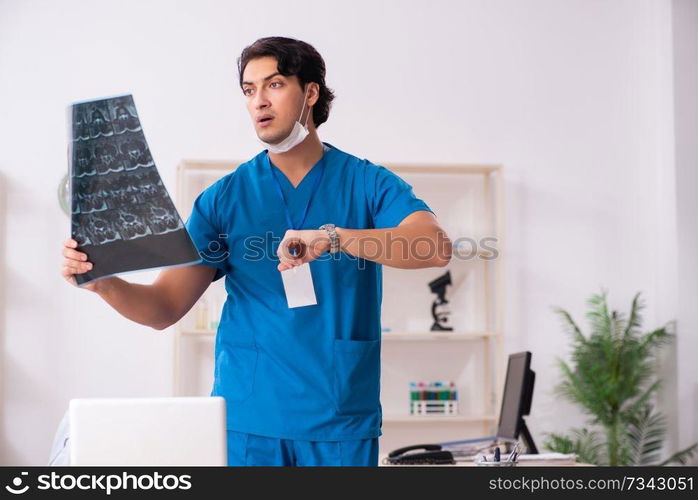 Young handsome doctor radiologist working in the clinic