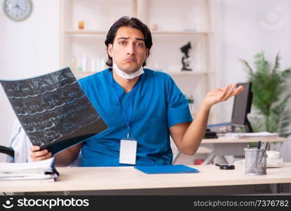 Young handsome doctor radiologist working in the clinic