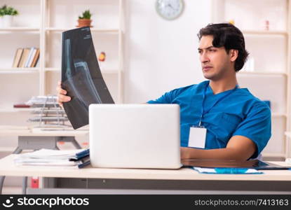 Young handsome doctor radiologist working in the clinic