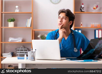 Young handsome doctor radiologyst working in clinic . The young handsome doctor radiologyst working in clinic 