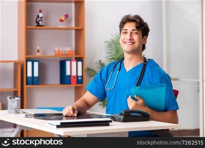Young handsome doctor radiologyst working in clinic . The young handsome doctor radiologyst working in clinic 
