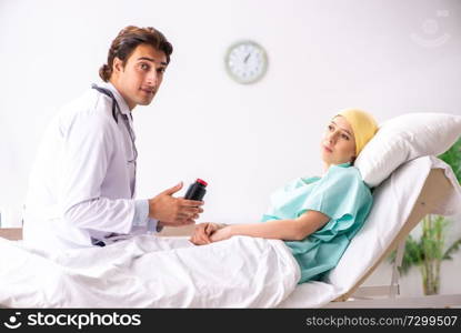 Young handsome doctor visiting female oncology patient 