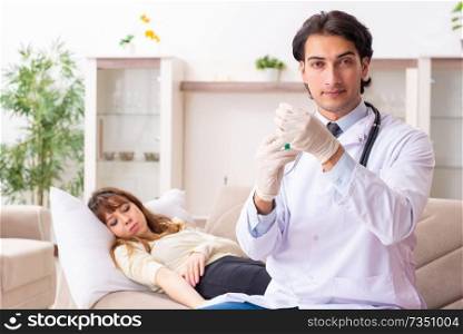 Young handsome doctor visiting female patient at home 