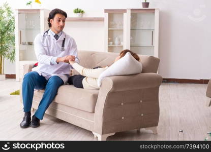 Young handsome doctor visiting female patient at home 